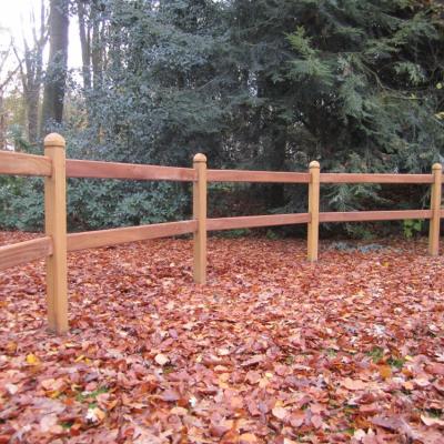 A curved wooden fence with square posts and two rails