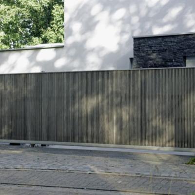 A wooden sliding driveway gate with a modern design and an intercom system