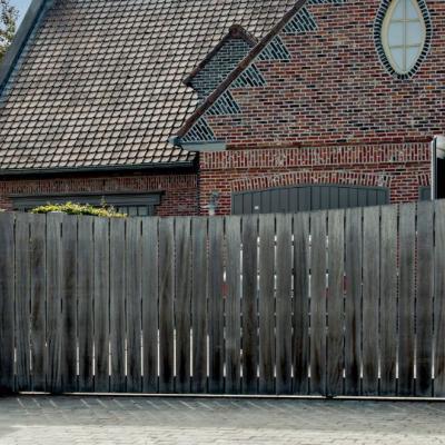 A sliding wooden residential gate with a modern design