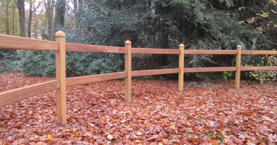 A curved wooden fence with square posts and two rails