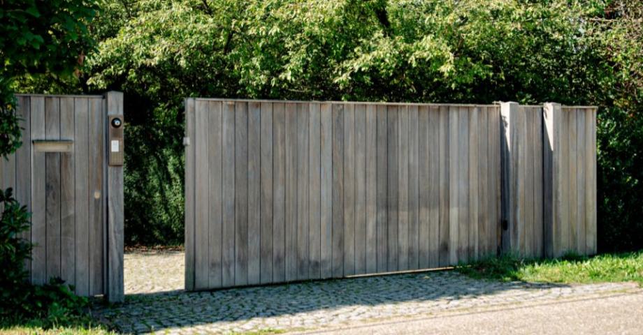 A sliding wooden gate with an intercom and video system